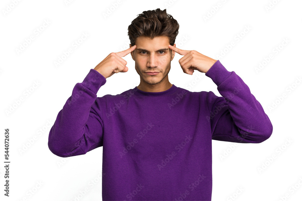 Young caucasian handsome man isolated focused on a task, keeping forefingers pointing head. Young caucasian handsome man isolated focused on a task, keeping forefingers pointing head.