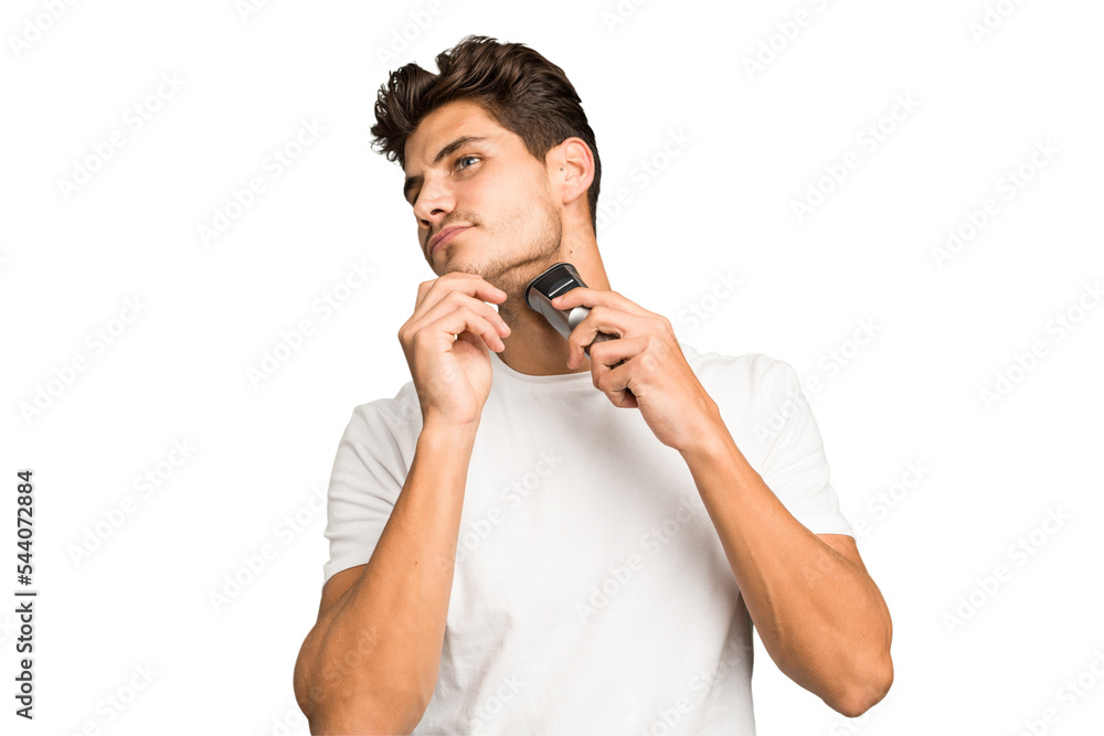 Young caucasian man shaving his beard with a razor isolated Young caucasian man shaving his beard with a razor isolated