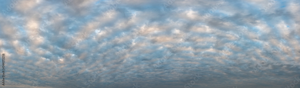 Panorama Gray stormy sky with cumulus clouds. Picturesque overcast sunset sky with many clouds. Air clouds background, full frame. Copy space. Soft focus.