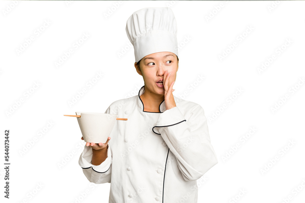 Young chef asian woman holding a bowl of ramen isolated is saying a secret hot braking news and looking aside Young chef asian woman holding a bowl of ramen isolated is saying a secret hot braking news and looking aside