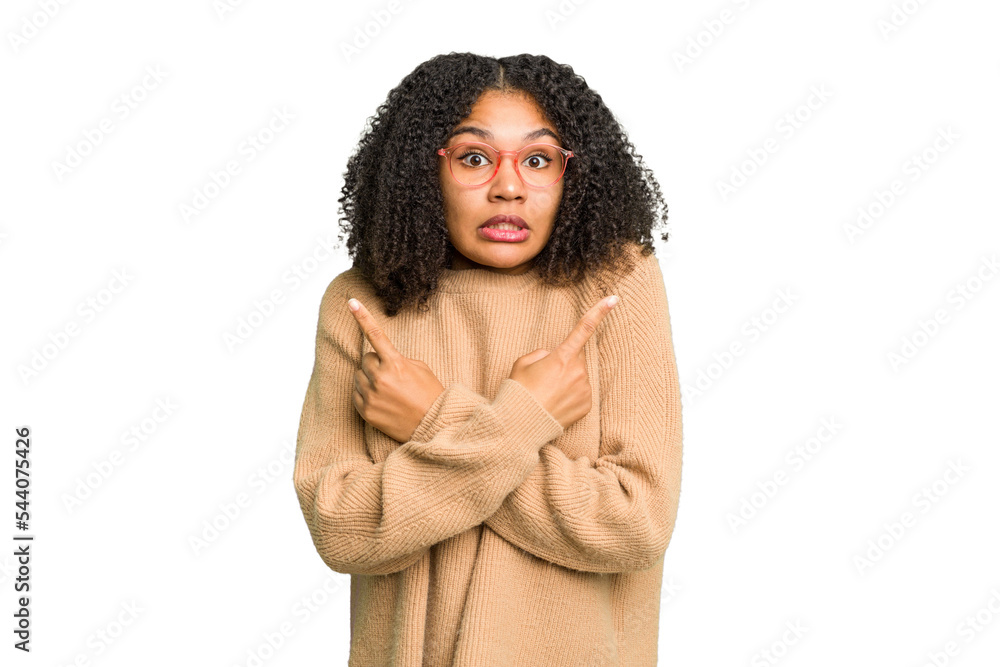 Young african american woman isolated points sideways, is trying to choose between two options. Young african american woman isolated points sideways, is trying to choose between two options.