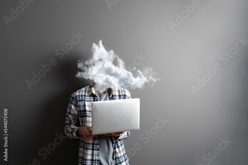 male employee working on computer with a cloud on the head photo