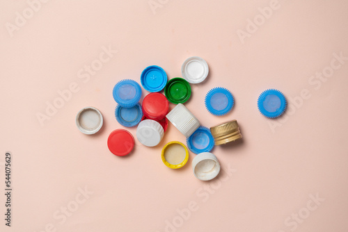 pile of colorful plastic caps for bottles on color table