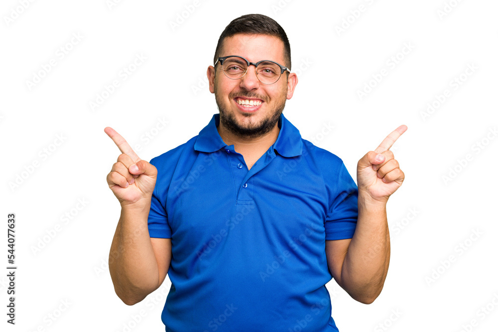 Young caucasian man isolated pointing to different copy spaces, choosing one of them, showing with finger. Young caucasian man isolated pointing to different copy spaces, choosing one of them, showing with finger.