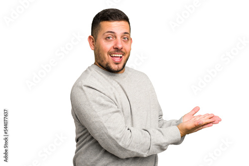 Young caucasian man isolated holding a copy space on a palm.