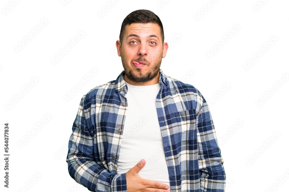 Young caucasian man isolated touches tummy, smiles gently, eating and satisfaction concept. Young caucasian man isolated touches tummy, smiles gently, eating and satisfaction concept.
