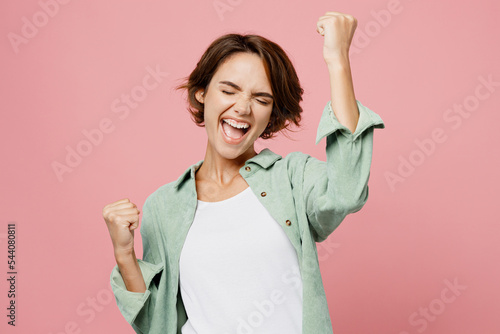 Print op canvas Young happy woman 20s she wear green shirt white t-shirt doing winner gesture ce