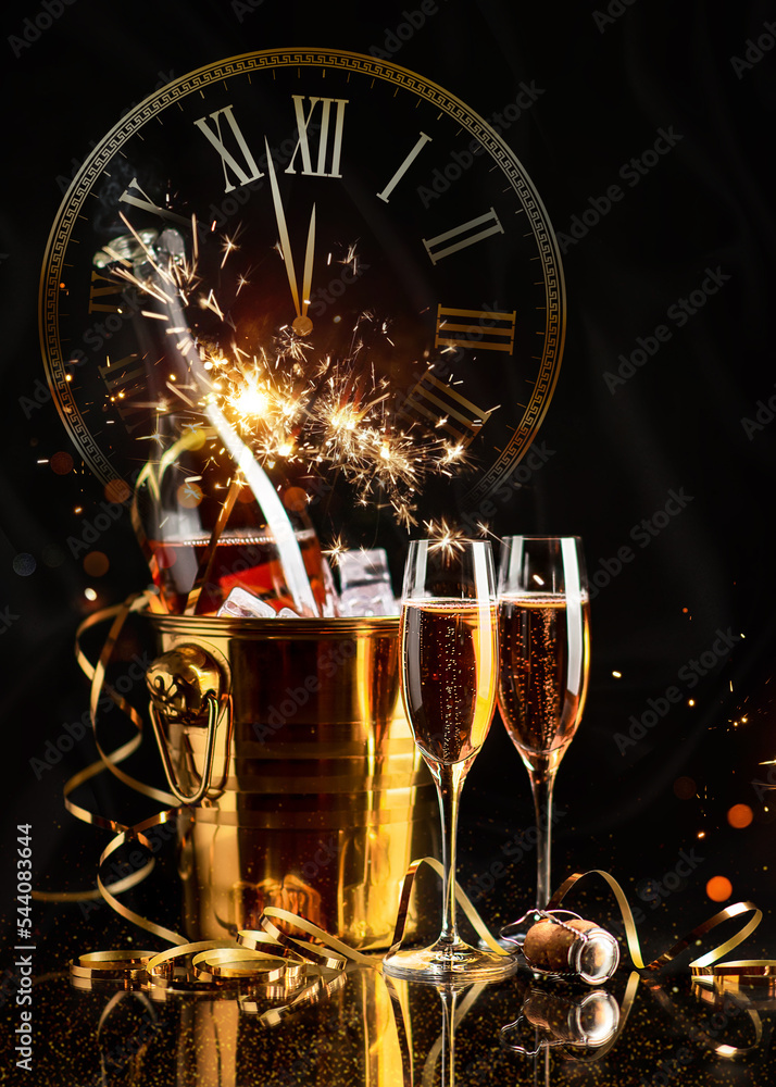 Happy New Year! A golden bucket with champagne, two glasses and a golden serpentine against the background of a clock face.