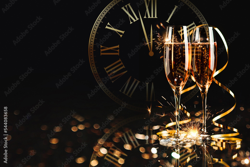 Happy New Year! A golden bucket with champagne, two glasses and a golden serpentine against the background of a clock face.