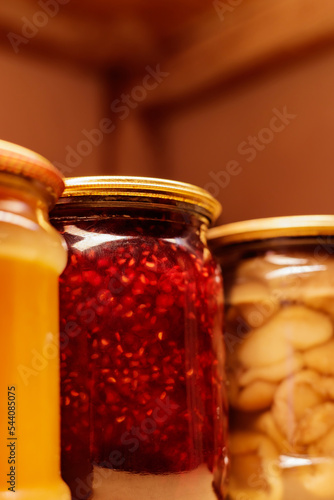 Canned vegetables and fruits. Jars with different canned vegetables in the pantry. Concept seasonal preserves. Copy space