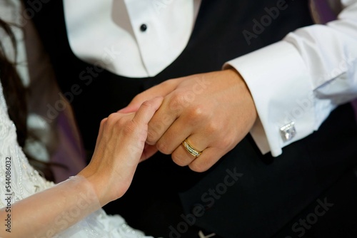 The hands of the bride and groom. Wedding ceremony or engagement celebration.