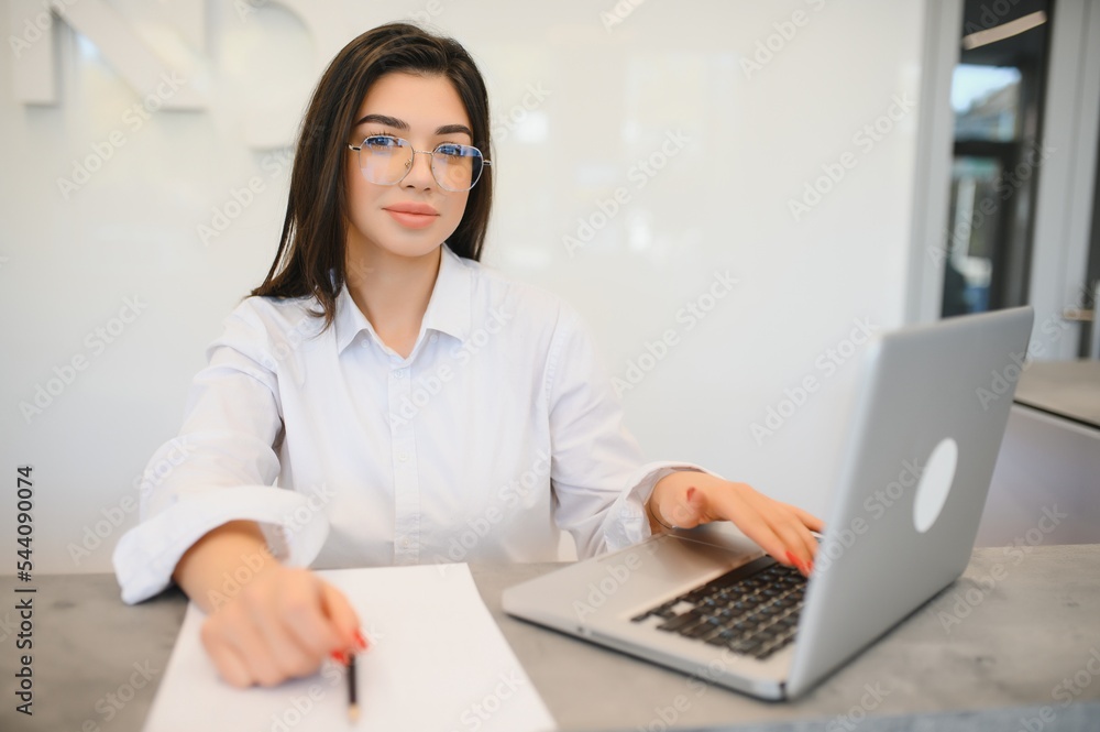Young female receptionist working in office Young female receptionist working in office