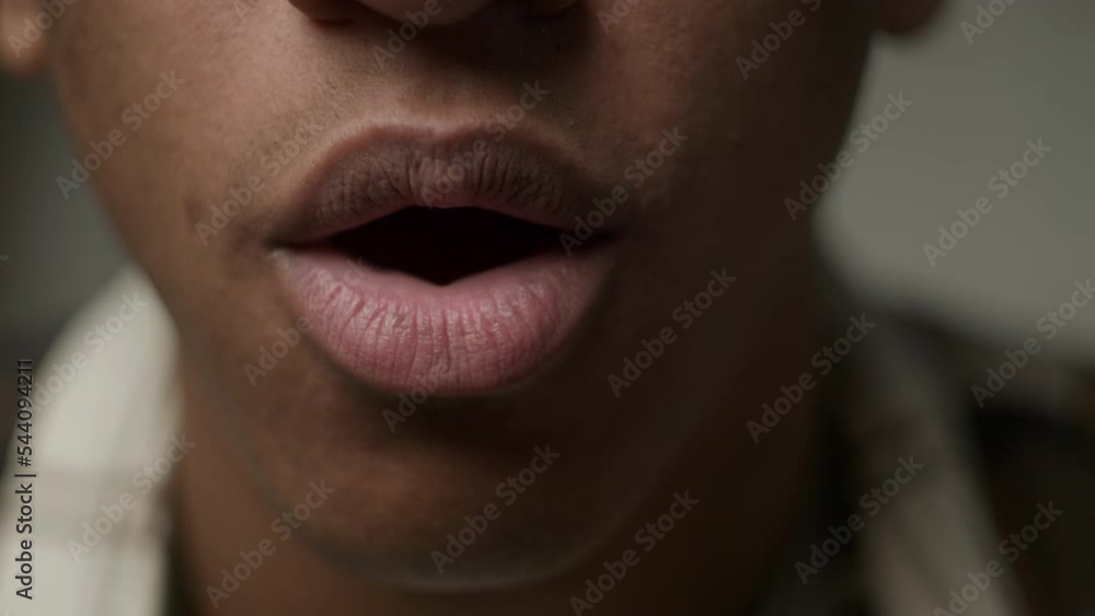 Black male mouth opening with wow emotion, close up. African American mans face showing surprise. Black male mouth opening with wow emotion, close up. African American mans face showing surprise.