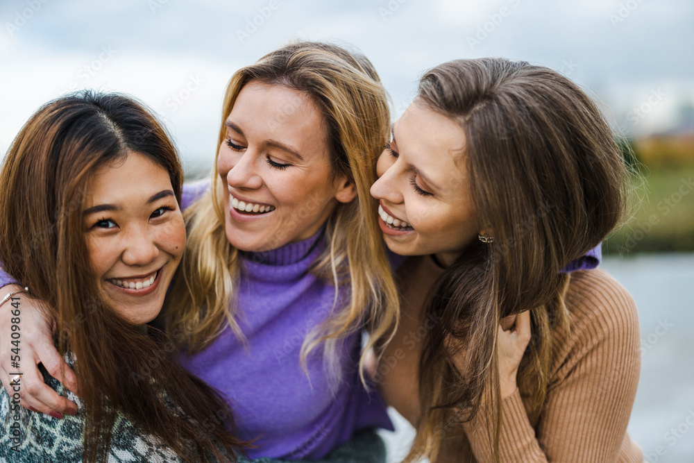 Three female friends hugging each other
Three female friends hugging each other