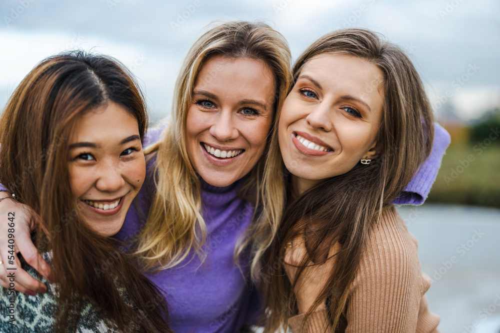 Three female friends hugging each other
Three female friends hugging each other
