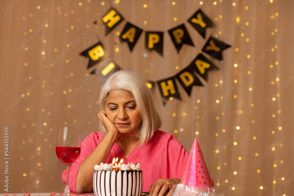 Old lady lonely celebrating her birthday at home Old lady lonely celebrating her birthday at home