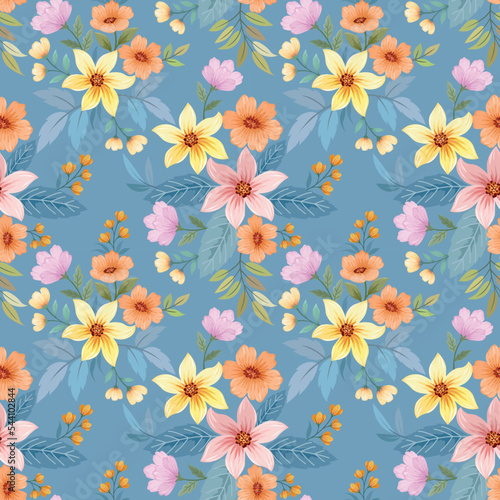 Colorful blooming flowers on blue color background seamless pattern for fabric textile wallpaper.