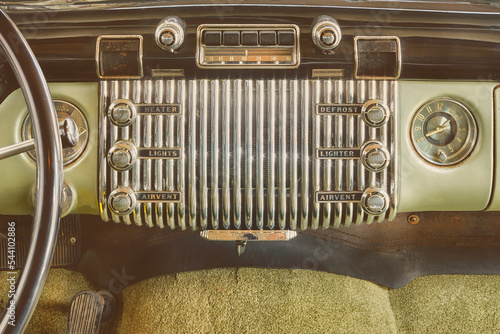 Old car radio inside a classic American car with chrome dashboard photo