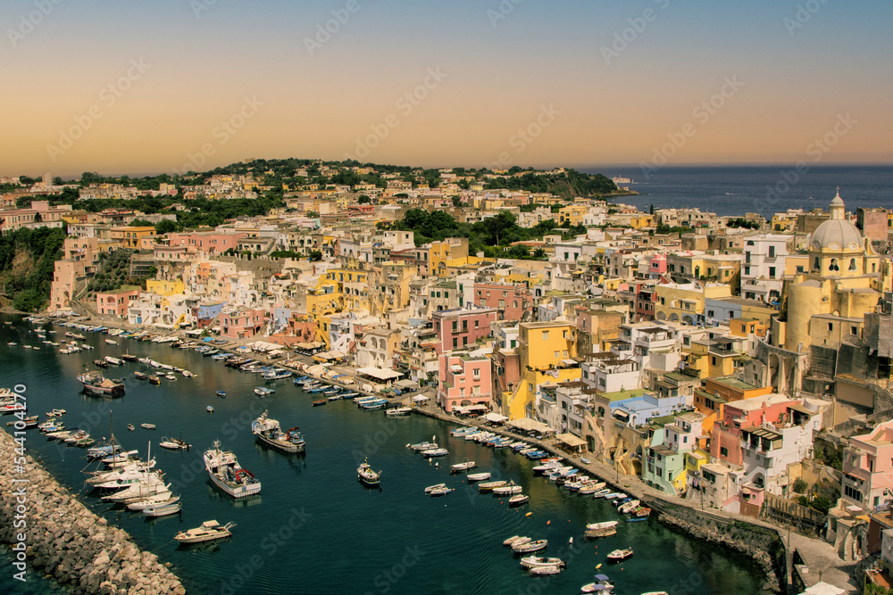 Procida island, Naples, Italy, colorful houses in Marina di Corricella harbour in sunset light