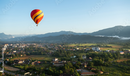 Aerial view of the sunrise at the city with a Hot Air Balloon at Vang Vieng Laos. Adventure concept. Tourism in Vang Vieng, Laos.