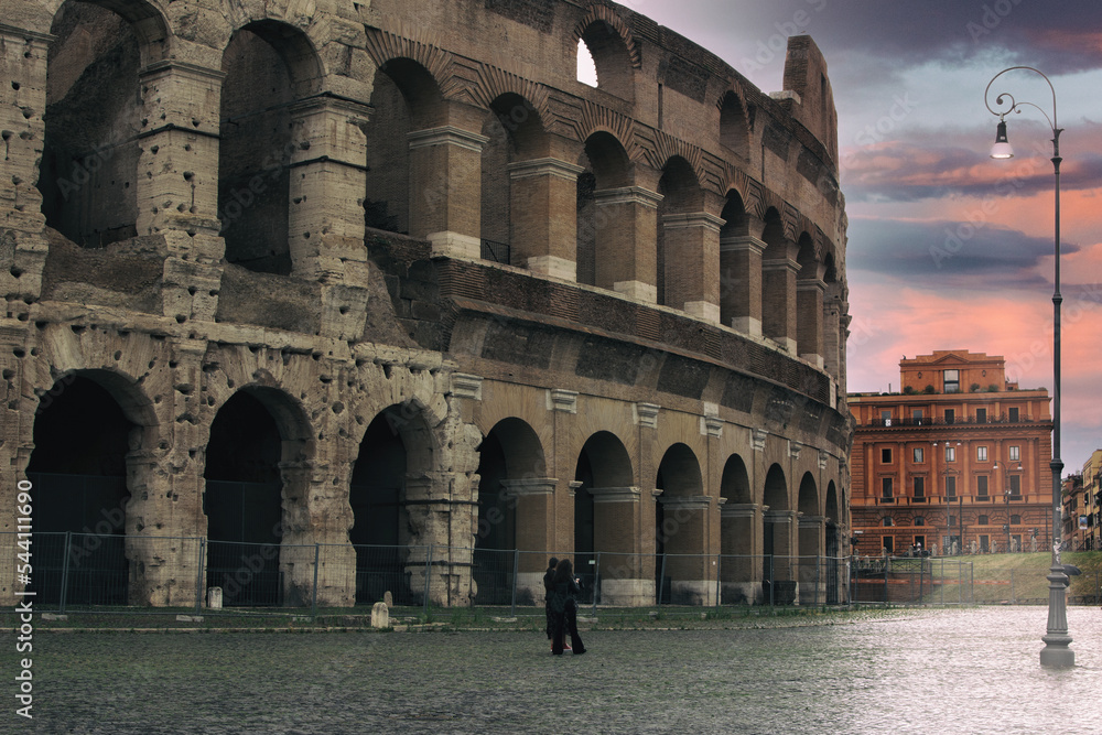 Rome, Italy at the Colosseum Amphitheater with the sunrise through the entranceway.