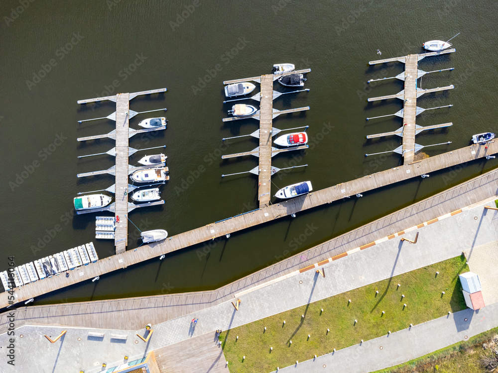 A harbor with yachts and boats seen from above. Aerial view. Sea, coast, island, parked boats. Photo from a drone.