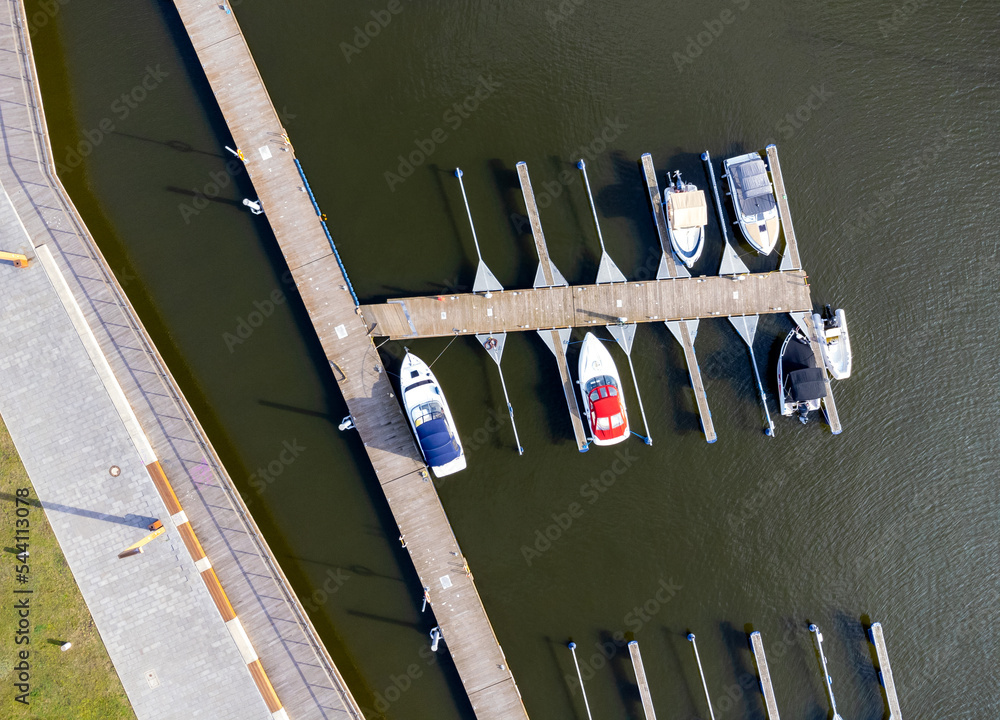 A harbor with yachts and boats seen from above. Aerial view. Sea, coast, island, parked boats. Photo from a drone.