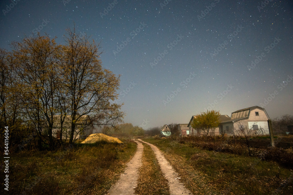 road in the night forest in the night . Night landscape. Nightsky and clouds . Stars in the sky . Lights of the city  . Evening forest  . Landscapes of Ukraine . Night and morning time 