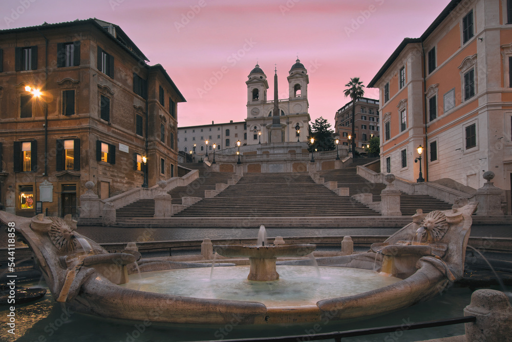 The Fontana della Barcaccia, at sunset, is a fountain found at the foot of the Spanish Steps in Rome's Piazza di Spagna (Spanish Square) created by Bernini. Rome Italy.