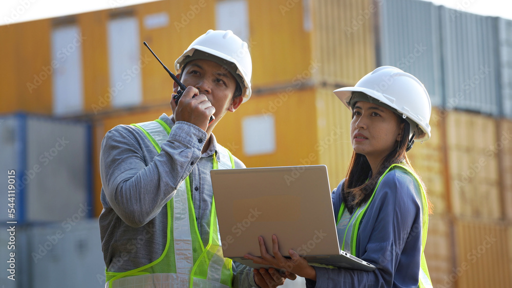 Two logistic staff discussing while checking and control loading containers box from cargo. Two logistic staff discussing while checking and control loading containers box from cargo.