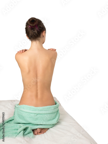 woman with bare back on massage table, before massage,Beautiful young woman, sitting with a bare back,Back and towel pose
