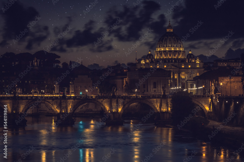 Ponte Sant`Angelo (Bridge of Holy Angel) and Basilica San Pietro (Saint Peter's cathedral) at night in Rome, Italy.