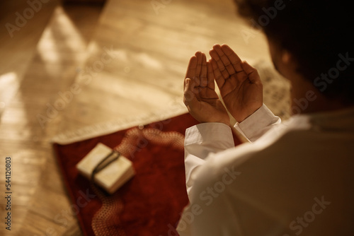 Tela Close up of Muslim believer reciting dua during prayer at home.