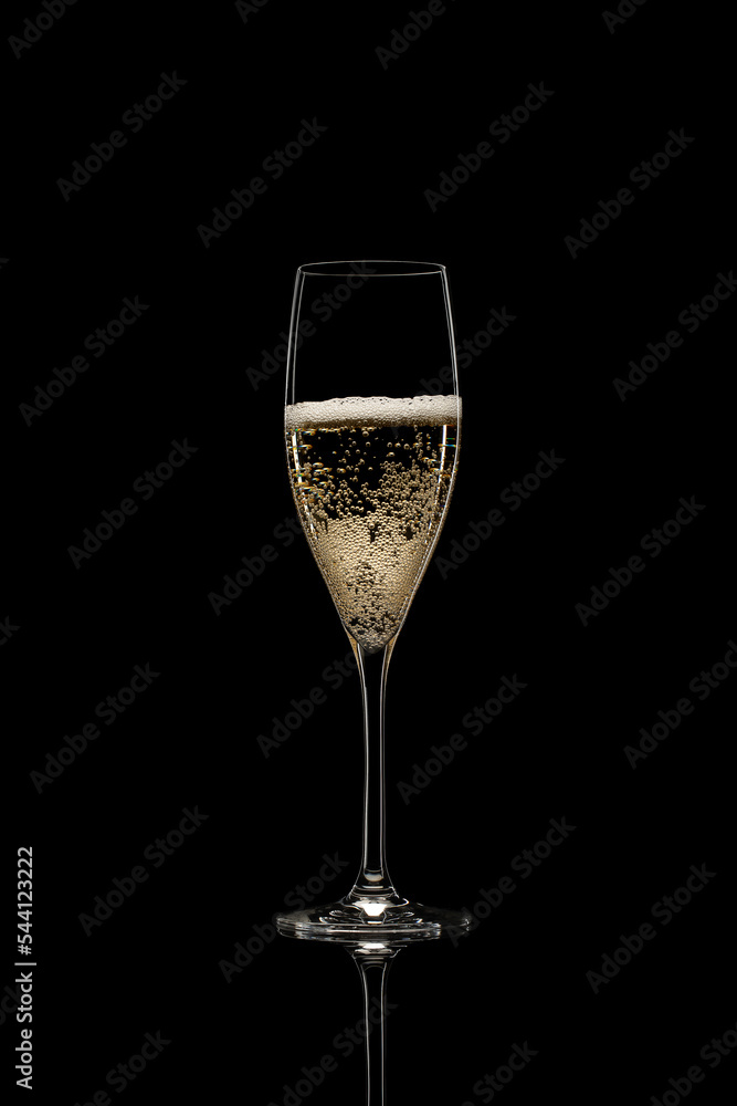 champagne on black background. Sparkling wine in glass, isolate