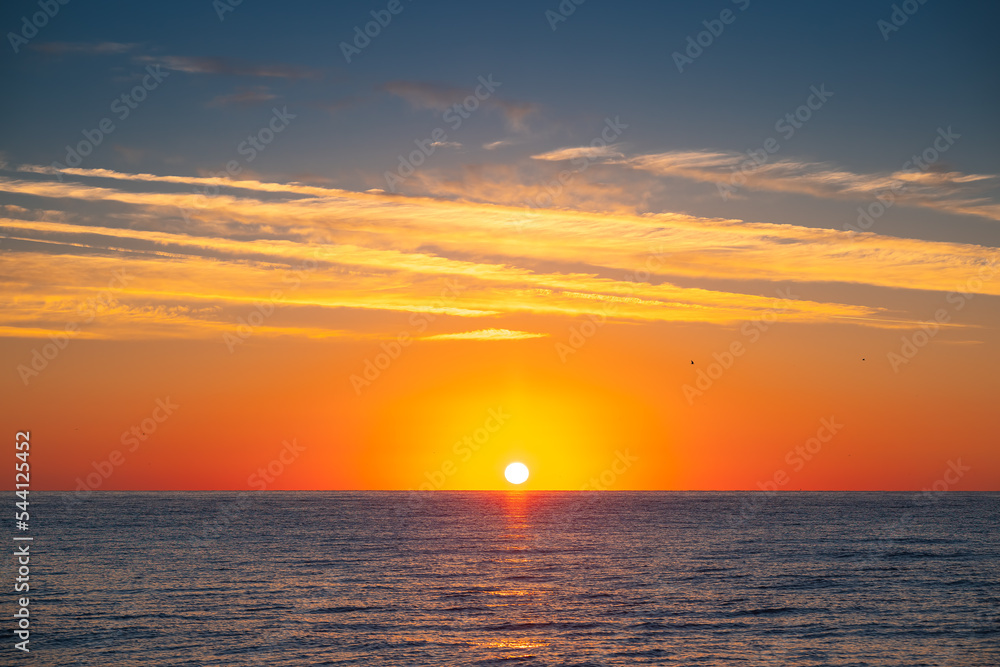 Beautiful scenic sunrise over the sea waves