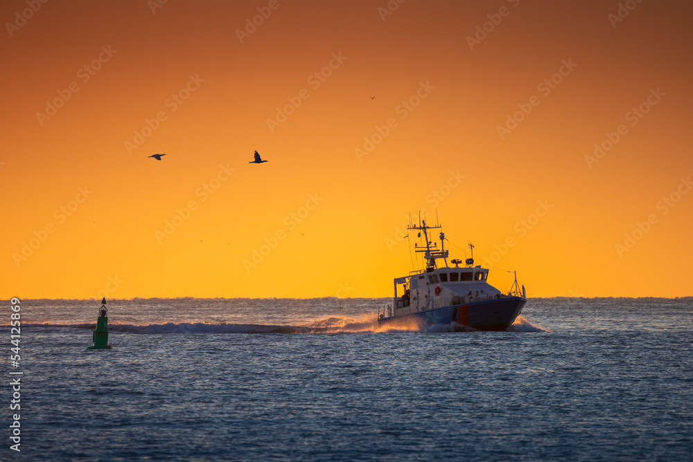 Boat in sea during golden sunrise