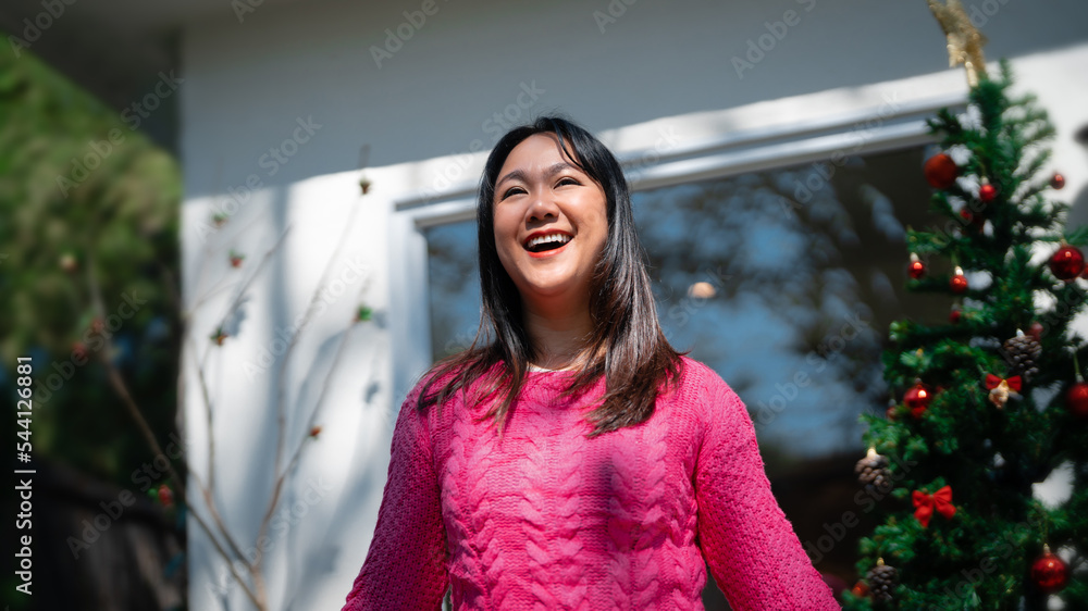 Attractive asian woman celebrating christmas holiday event.