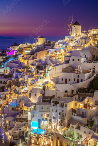 Romantic night view of traditional Greek village Oia on Santorini island in Greece. Santorini is iconic travel destination in Greece, famous of its sunsets and traditional white architecture.