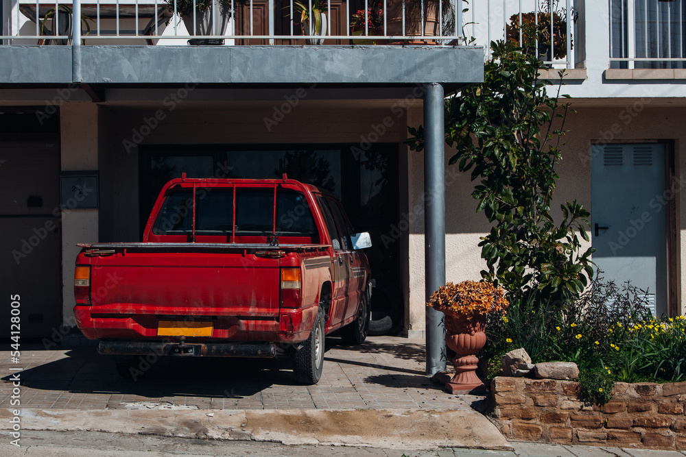 Fototapeta premium Old vintage pick up car is parked near house
