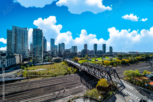 Photography Toronto  train yard  with buildings in background and clouds