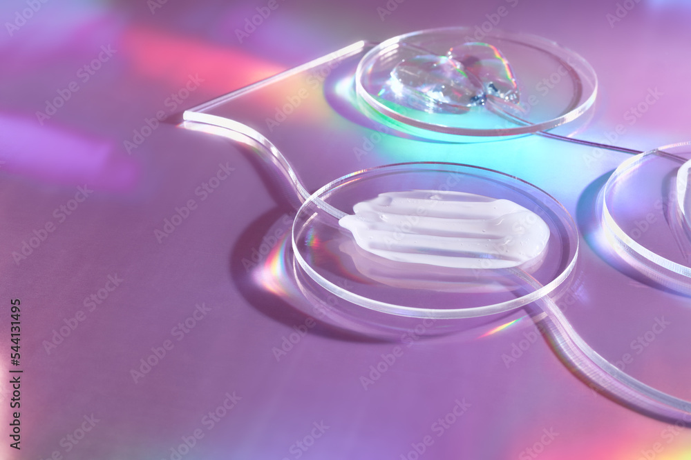 Smears of cream in petri dish on holographic background with iridescent highlights Smears of cream in petri dish on holographic background with iridescent highlights