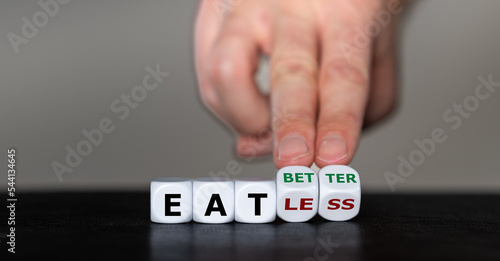 Hand turns dice and changes the expression 'eat less' to 'eat better'.