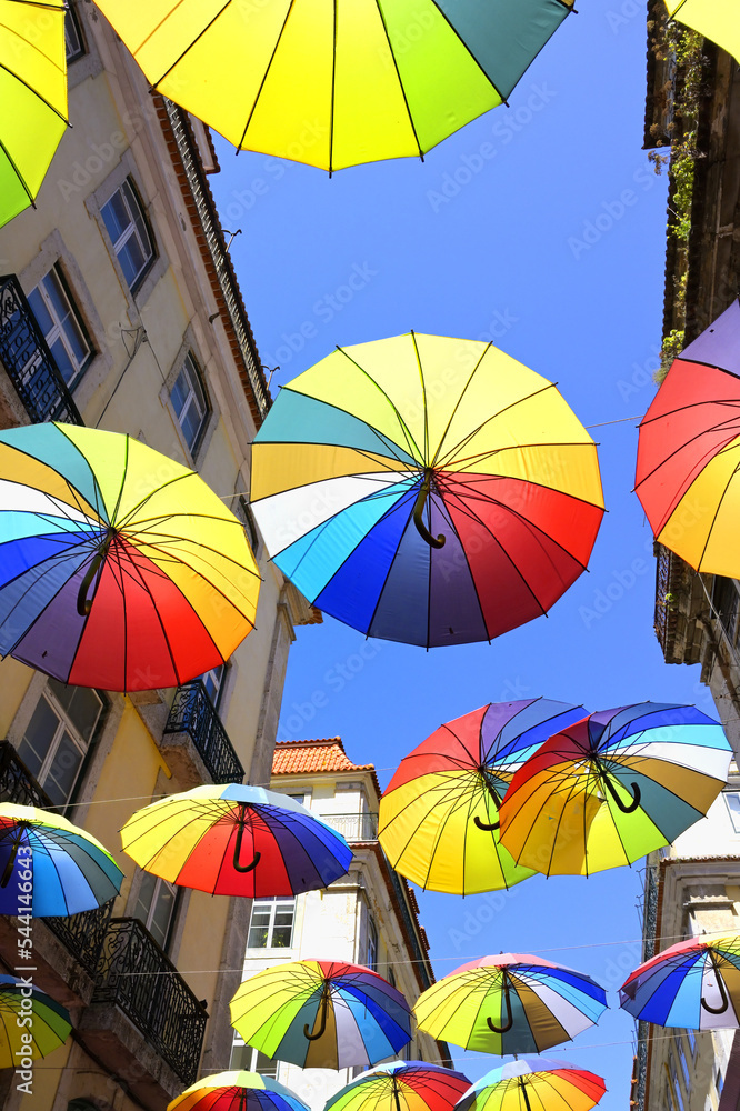 Colorful umbrellas suspended over Pink Street, Lisbon, Portugal