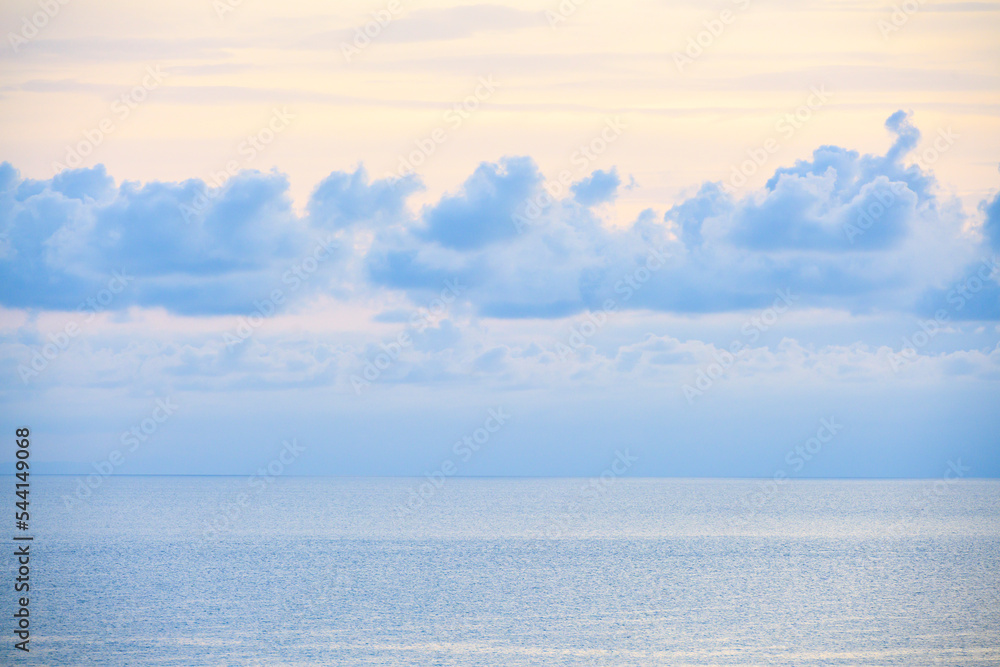 Fototapeta premium Blue clouds on the calm sea