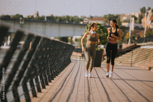 Young woman taking running ...