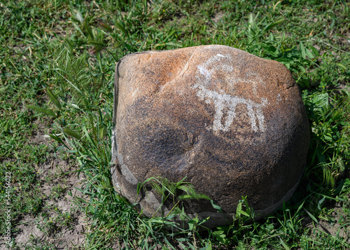 Ancient rock painting (petroglyphs) of an animal with horns dated from II millenium B.C. in the Burana settlement in Kyrgyzstan
