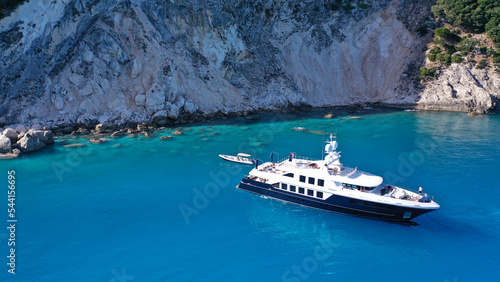 Aerial drone photo of large luxury yacht anchored in paradise Mediterranean bay with turquoise crystal clear sea © aerial-drone
