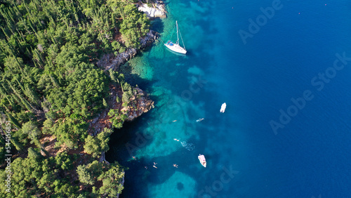 Aerial drone photo of beautiful bay and beach of Foki with iconic caves visited by yachts and sail boats, Kefalonia island, Ionian, Greece