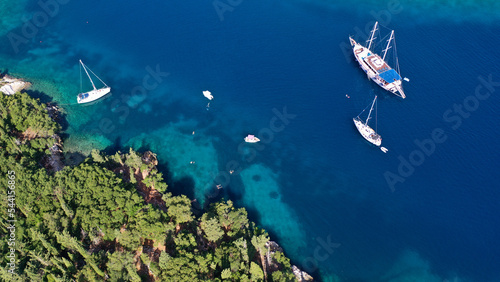 Aerial drone photo of beautiful bay and beach of Foki with iconic caves visited by yachts and sail boats, Kefalonia island, Ionian, Greece