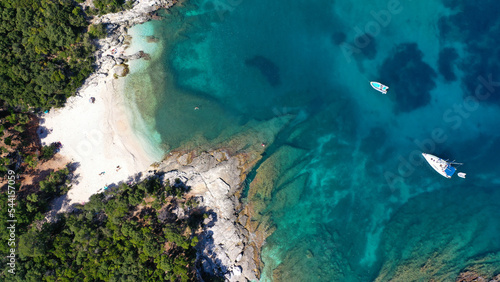 Aerial drone top down photo of tropical exotic paradise secluded rocky bay with deep turquoise sea forming a blue lagoon © aerial-drone